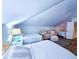 Bright bedroom featuring multiple beds, cozy seating area, and stylish decor under vaulted ceiling at 837 Club Cottage Rd, Edisto Island, SC 29438
