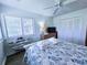 Comfortable bedroom with coastal accents, featuring a plush bed, ample natural light, and a spacious closet at 837 Club Cottage Rd, Edisto Island, SC 29438