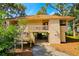 Inviting condo exterior decorated with patriotic bunting and flags, featuring a charming entryway and well-maintained landscaping at 837 Club Cottage Rd, Edisto Island, SC 29438