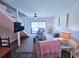 Bright living room with modern decor, a comfortable sofa, stylish rug, and a sliding glass door leading to outdoor space at 837 Club Cottage Rd, Edisto Island, SC 29438