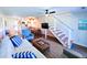 Cozy living area features an open design, dining space, and modern staircase at 837 Club Cottage Rd, Edisto Island, SC 29438