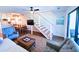 Stylish living space with staircase, updated decor, and access to a screened porch at 837 Club Cottage Rd, Edisto Island, SC 29438