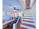 Open living area featuring a staircase, comfortable seating, and modern decor at 837 Club Cottage Rd, Edisto Island, SC 29438