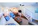 Bright living area featuring stairs, wood floors, modern decor, and an open concept design at 837 Club Cottage Rd, Edisto Island, SC 29438