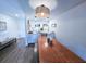 Open-concept living space with dining table that leads into a bright modern kitchen featuring white cabinets at 837 Club Cottage Rd, Edisto Island, SC 29438