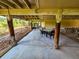 Expansive covered patio with comfortable seating and beautiful landscape perfect for outdoor gatherings and relaxation at 837 Club Cottage Rd, Edisto Island, SC 29438