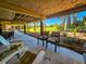 Outdoor seating area with view of green lawn and trees, perfect for relaxing at 837 Club Cottage Rd, Edisto Island, SC 29438
