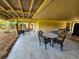 Relaxing outdoor patio with comfortable seating and a swing, perfect for enjoying the serene surroundings at 837 Club Cottage Rd, Edisto Island, SC 29438