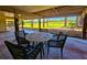 Inviting patio features a table with four chairs overlooking a well-manicured lawn at 837 Club Cottage Rd, Edisto Island, SC 29438