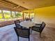 Outdoor patio features a table with four chairs for relaxing and enjoying outdoor living at 837 Club Cottage Rd, Edisto Island, SC 29438
