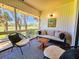 Relaxing screened porch with comfortable seating and picturesque outdoor views at 837 Club Cottage Rd, Edisto Island, SC 29438