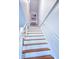 Bright and clean staircase with wood treads and white risers and handrail at 837 Club Cottage Rd, Edisto Island, SC 29438