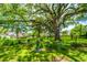 Lush backyard with mature trees, manicured lawn, and garden features at 88 Smith St, Charleston, SC 29401