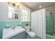 Bright bathroom with retro green tile, a white sink, and a shower with a curtain at 88 Smith St, Charleston, SC 29401