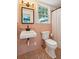 Quaint bathroom featuring pink tile, a wall-mounted sink, and a window for natural light at 88 Smith St, Charleston, SC 29401