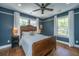 Comfortable bedroom with a wooden bed frame, ceiling fan, natural light, and hardwood floors at 88 Smith St, Charleston, SC 29401