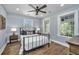 Serene bedroom with a wrought iron bed frame, natural light, and hardwood floors at 88 Smith St, Charleston, SC 29401