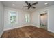 Bright, neutrally painted bedroom with a ceiling fan and hardwood floors, leading to an en-suite bathroom at 88 Smith St, Charleston, SC 29401