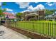 Charming brick home with a well-manicured lawn and a black iron fence at 88 Smith St, Charleston, SC 29401