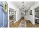 Bright foyer with hardwood floors, decorative chandelier, and open doorway to a modern kitchen at 88 Smith St, Charleston, SC 29401