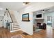 Bright foyer with hardwood floors, staircase, and open entryway into living space at 88 Smith St, Charleston, SC 29401