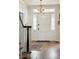 Inviting foyer with hardwood floors, white door and trim, and decorative chandelier at 88 Smith St, Charleston, SC 29401
