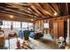 A spacious garage featuring a golf cart, wood walls, wood trusses, and two windows for natural light at 88 Smith St, Charleston, SC 29401