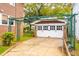 A detached two-door garage featuring a pergola-covered walkway and mature landscaping at 88 Smith St, Charleston, SC 29401
