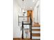 Charming two-story home featuring a bright hallway with hardwood floors and stylish staircase at 88 Smith St, Charleston, SC 29401