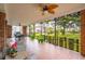 Large porch features brick columns and wrought iron railings with seating and views of the yard at 88 Smith St, Charleston, SC 29401