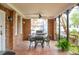 Covered porch with brick columns and iron railings, featuring a table, chairs, and grill at 88 Smith St, Charleston, SC 29401