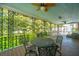 Inviting porch with ornate railings, ceiling fans, and outdoor dining set for relaxing and entertaining at 88 Smith St, Charleston, SC 29401