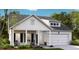 Charming home with a two-car garage, a covered porch, and beautiful landscaping at 1027 Riverbed Retreat Ln, Summerville, SC 29483