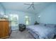 Cozy bedroom with a ceiling fan, two windows, and a comfortable queen-sized bed at 103 Toura Ln, Charleston, SC 29414