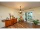 Dining area with hardwood floors, sliding glass doors, and a stylish light fixture, perfect for entertaining at 103 Toura Ln, Charleston, SC 29414