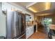Bright kitchen with stainless refrigerator, granite counters, and access to the yard at 103 Toura Ln, Charleston, SC 29414