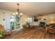 Cozy living room featuring a fireplace, hardwood floors, and natural light from sliding doors leading to the deck at 103 Toura Ln, Charleston, SC 29414