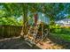 A quaint treehouse with a ladder sits nestled among the trees in the backyard at 103 Toura Ln, Charleston, SC 29414