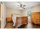 Bright bedroom with hardwood floors, a ceiling fan, window, and wooden furniture, creates an inviting space at 105 Birkbeck Ct, Goose Creek, SC 29445