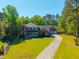 Two-story brick home with a well-manicured lawn, front porch, and attached garage at 105 Birkbeck Ct, Goose Creek, SC 29445