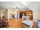 Open-concept living room and kitchen features a fireplace, island seating, wood floors, and modern appliances at 105 Birkbeck Ct, Goose Creek, SC 29445