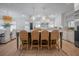 Open-concept kitchen with a large island, wicker chairs, and decorative pendant lighting at 108 Live Oak Dr, Mount Pleasant, SC 29464