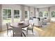Bright living room with an adjacent dining area, large windows, and light hardwood floors at 111 Pen Shell St, Summerville, SC 29485