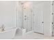 This luxury bathroom features marble flooring, a glass enclosed shower, and a soaking tub at 114 Battle Boat Blvd, Summerville, SC 29485