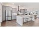 Well-lit kitchen with stainless steel appliances, a spacious island with seating, and an adjacent dining area at 114 Battle Boat Blvd, Summerville, SC 29485