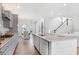 Open-concept kitchen boasts a large island with seating, stainless steel faucet, and seamless flow to other living spaces at 114 Battle Boat Blvd, Summerville, SC 29485