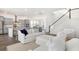 Open-concept living space with stairs, a white sofa set, and a view into the modern kitchen at 114 Battle Boat Blvd, Summerville, SC 29485