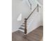 Modern staircase with wood handrail and gray treads is naturally illuminated at 114 Battle Boat Blvd, Summerville, SC 29485