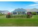 Scenic backyard with a well-maintained lawn, privacy fence, and colorful flowers at 123 Leeward Lndg, Summerville, SC 29486
