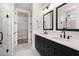 Bathroom with dual sinks, black hardware, white marble countertops, and walk-in closet at 123 Leeward Lndg, Summerville, SC 29486